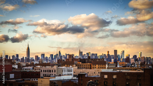 New York City Midtown skyline at sunset with fall clouds.