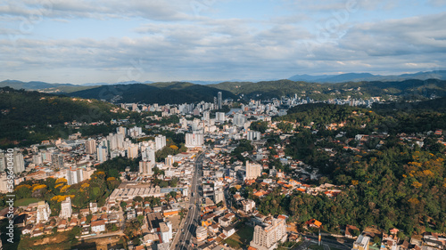 aerial image of downtown Blumenau, with Itajaí Açú River, Santa Catarina, southern Brazil, buildings, main streets, vegetation and sunny day © Thiago