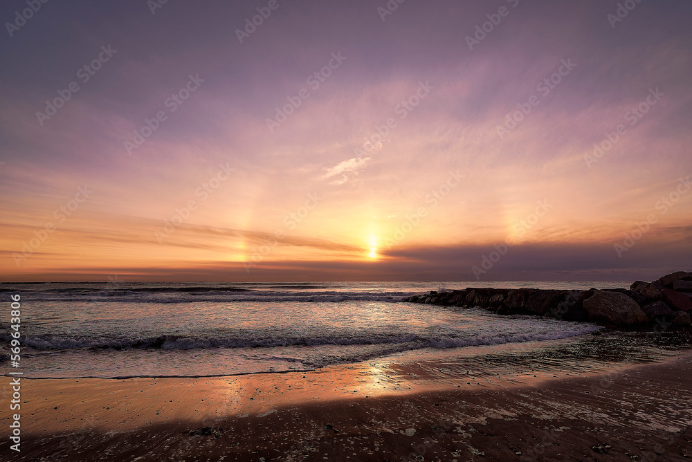 Rainbow sunrise on a deserted Mediterranean beach