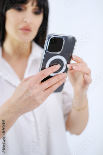 Selective focus woman with cell phone white background
