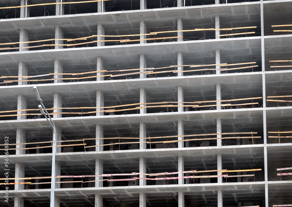 View of the facade of an unfinished construction of a building using monolithic frame technology View of the facade of an unfinished construction of a building using monolithic frame technology