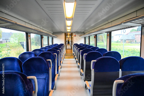 The interior of a modern passenger train. Traveling by railways. Interior of train wagon with seats. 