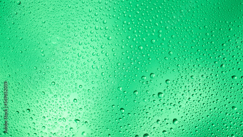 Glowing gradient green background with contrasting water drops