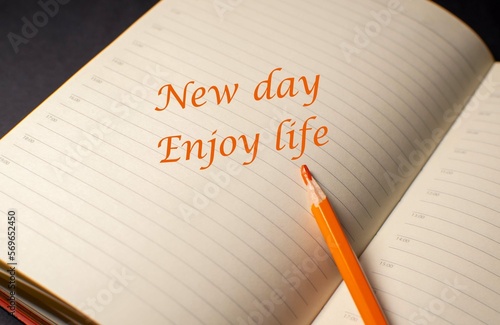 Motivators for every day. The inscription in orange pencil on the page of the open diary 