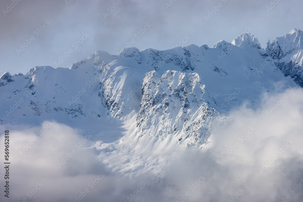 Tantalus Range covered in Snow and Clouds during Winter Season. Near Whistler and Squamish, British Columbia, Canada. Nature Background