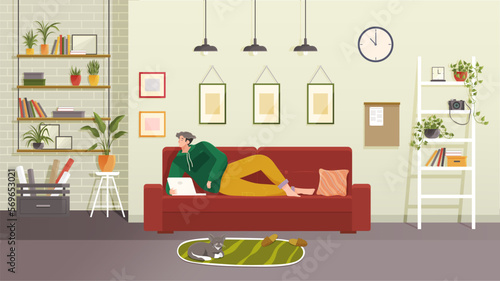 Young man sits on sofa and work from home with laptop, relaxing and surfing Internet. Cat lies on mat next to owner. Concept living room with sofa, plants, man, lamps. Person indoor job remote work