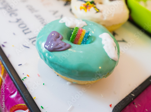 bright green donut with cream lies on the table. Closeup photo