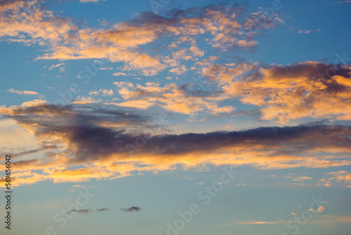 clouds against the sunset sky. Illuminated in orange