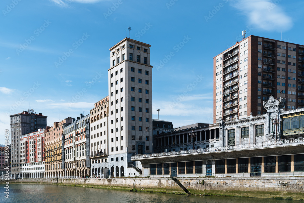 Traditional residential buildings and skyscraper of Bailen in the riverside of Nervion River in the Old Quarter of Bilbao