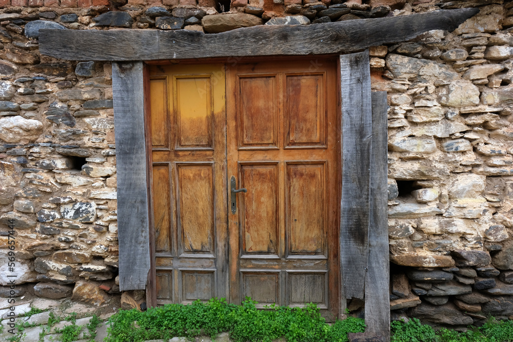 Wooden door of a house with stone walls in Bayındır Yusuflu village, Izmir, Turkey