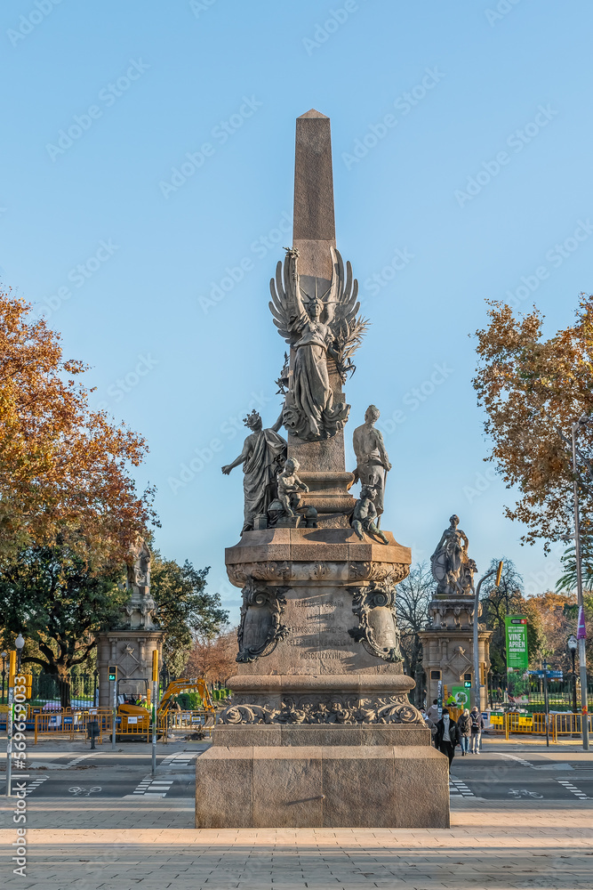 Barcelona, Spain -November 26,2021: Back of the monument to the mayor Francesc de Paula Rius i Taulet with Ciutadella Park in Barcelona in the background. Obelisk by Pere Falques and Manuel Fuxa, 1901