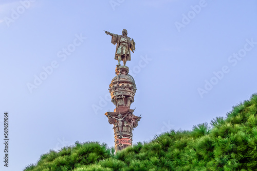 Barcelona, Spain - November 26, 2021: Monument a Colom in Barcelona, close-up. Statue of Christopher Columbus on top of Corinthian column, isolated on a blue sky. Author: Gaieta Buigas i Monrava, 1888 photo