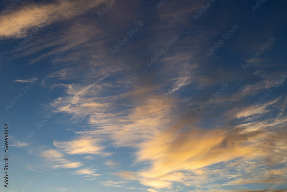 blue sky with golden clouds beautifully illuminated by the sun as a natural background