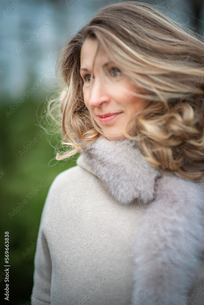 Portrait of a young beautiful fair-haired girl in a winter fur coat. Portrait of a young beautiful fair-haired girl in a winter fur coat.