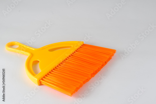 orange broom on white