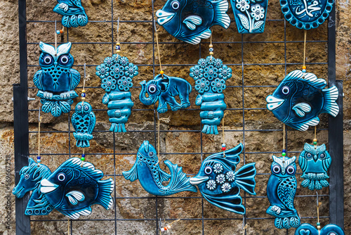 Various  animalss,  plates, cat corals and other marine jewelry souvenirs in the shop photo