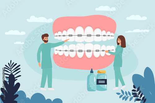 Orthodontist installs dental braces for straightening. Tiny Dentist doctor research X-ray picture of tooth. Dentistry, braces installation, teeth alignment. Prosthetics, Orthodontic treatment.