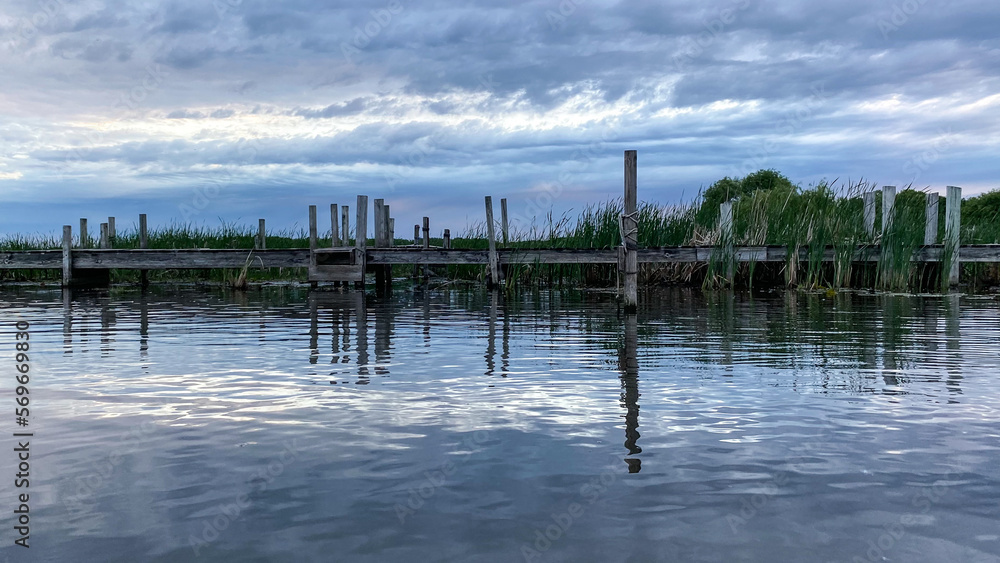pier on the lake in the cloudy evening pier on the lake in the cloudy evening