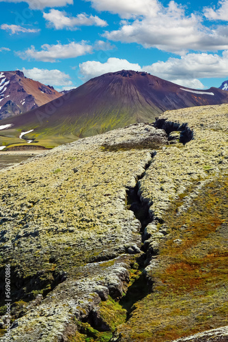 Fissure of the ground leading to cone of black volcano crater cone - Grabrok Grabrokarfell Iceland photo