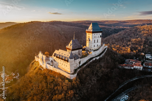 Aerial view of gothic Royal Karlstejn Castle with Czech crown jewels,Czech Republic.Most popular Czech castle at sunset.Amazing historical monument in central Europe.Czech landmark,tourist attraction