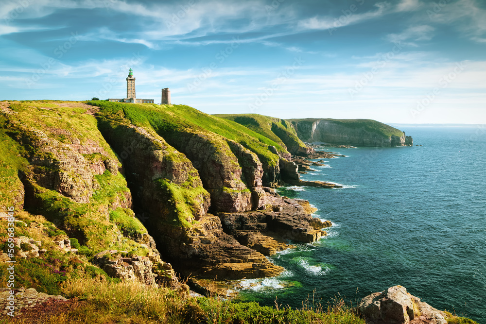 Panoramic view of scenic coastal landscape with traditional lighthouse at famous Cap Frehel peninsula on the Cote d'Emeraude, commune of Plevenon, Cotes-d'Armor, Bretagne, northern France - obrazy, fototapety, plakaty 