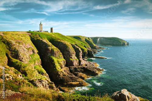 Panoramic view of scenic coastal landscape with traditional lighthouse at famous Cap Frehel peninsula on the Cote d'Emeraude, commune of Plevenon, Cotes-d'Armor, Bretagne, northern France