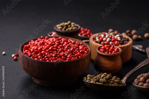 Composition, concept, consisting of several types of different colors of allspice in bowls and spoons