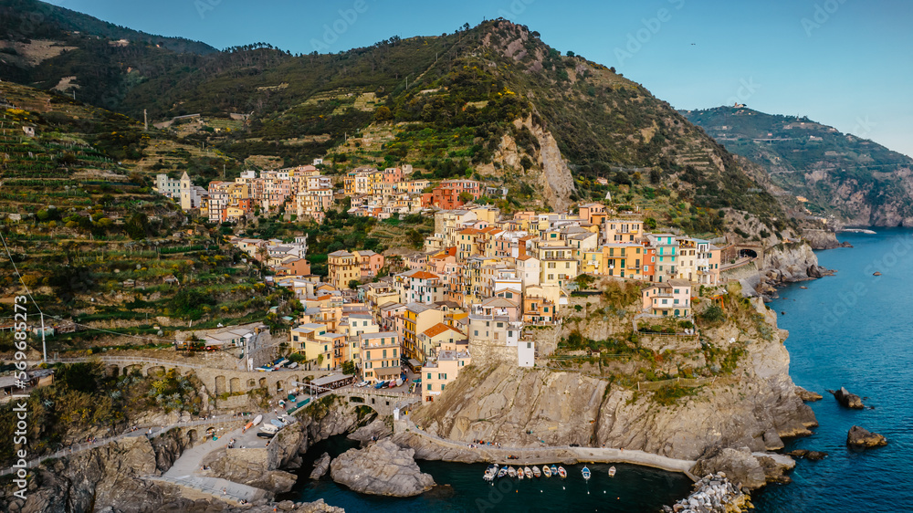 Aerial view of Corniglia and coastline of Cinque Terre,Italy.UNESCO Heritage Site.Picturesque colorful village on rock above sea.Summer holiday,travel scene.Italian Riviera landscape.Mediterranean