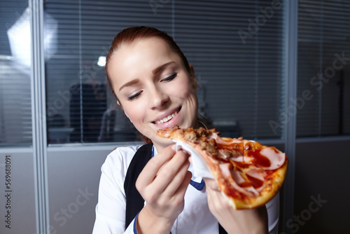 businesswomen with pizza in office