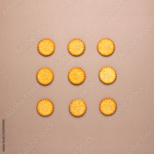 Creative layout made of biscuits arranged in a square on a brown background. Flat lay. Food concept