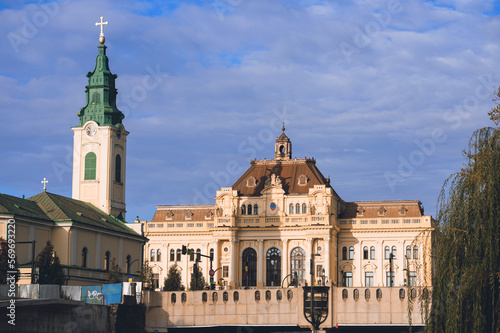 Travel to Oradea, Romania. Highlight the significant religious sites of Oradea, including churches, synagogues, and temples. stunning Art Nouveau architecture of Oradea