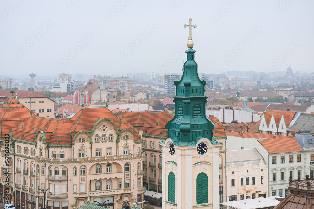 Oradea culture and history. Highlight the historic city centers of Oradea, with their charming cobblestone streets, historic buildings, and vibrant local life, churches, synagogues, and temples