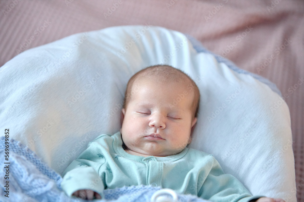 the newborn boy is sleeping. cute beautiful baby is sleeping closeup portrait of a beautiful sleeping baby on white. the newborn boy is sleeping. cute beautiful baby is sleeping closeup portrait of a beautiful sleeping baby on white.