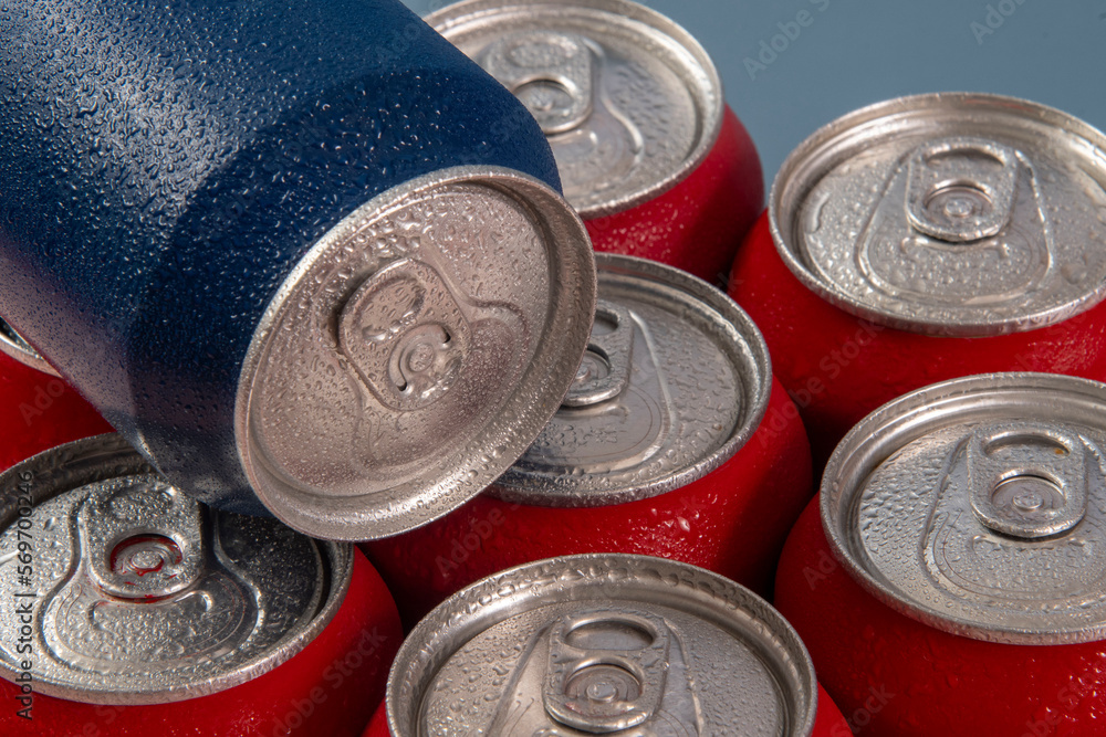 Cold red soda cans with a blue one for conceptual use Cold red soda cans with a blue one for conceptual use