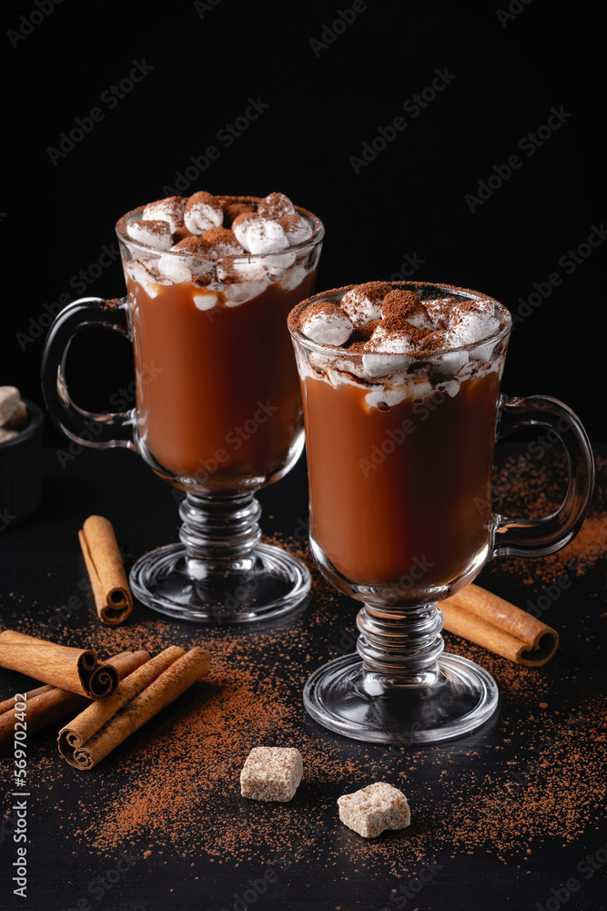 Two cups of hot chocolate, cocoa or warm drink with marshmallows on dark background Two cups of hot chocolate, cocoa or warm drink with marshmallows on dark background