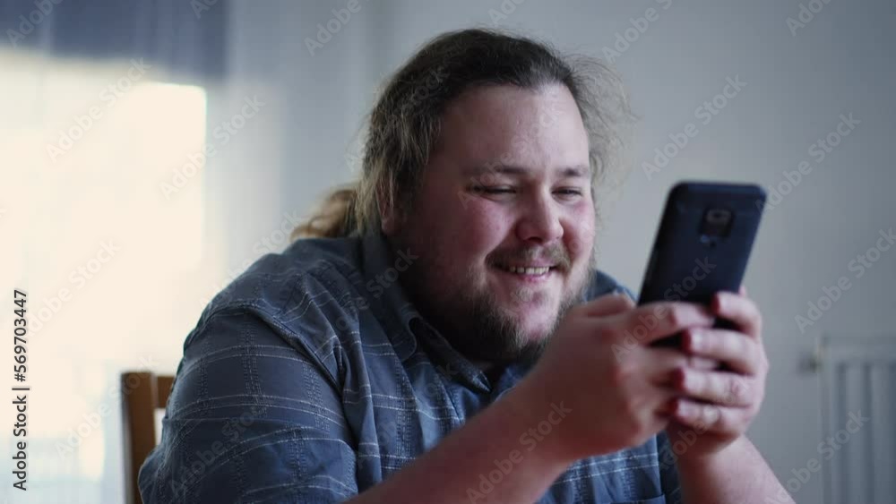 Joyful guy holding phone liking content online. Happy emotion of male casual person feeling excitement Joyful guy holding phone liking content online. Happy emotion of male casual person feeling excitement