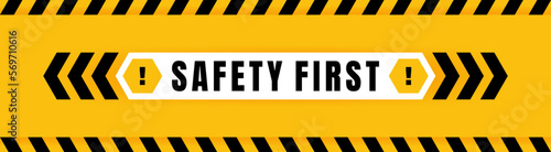Safety first badge placed on yellow background with black and yellow line striped. Attention label with Exclamation mark on hexagon. Vector illustration