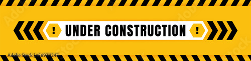 Under construction badge placed on yellow background with black and yellow line striped. Attention label with Exclamation mark on hexagon. Vector illustration