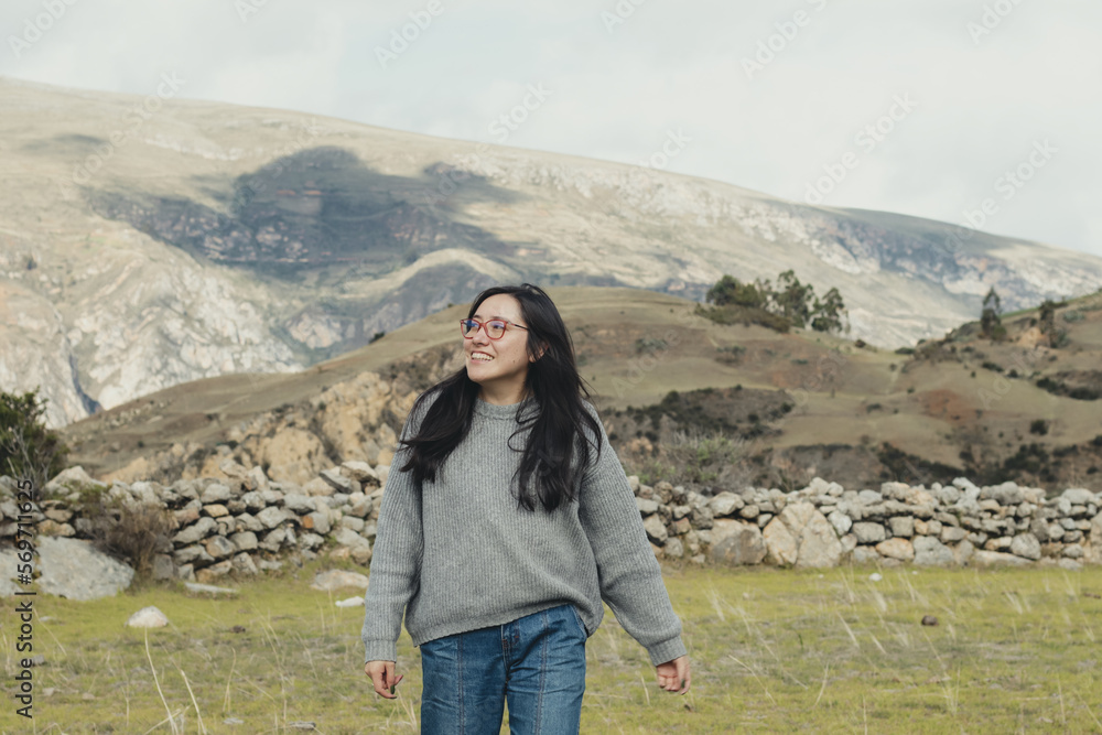Portrait of woman enjoying her vacation in a mountain landscape in the Andes Mountains in South America. Concept of people, travel and vacation.