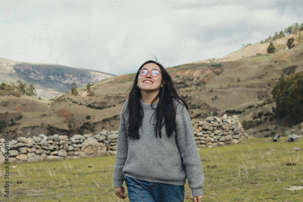 Portrait of woman enjoying her vacation in a mountain landscape in the Andes Mountains in South America. Concept of people, travel and vacation.