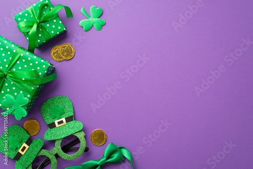 Saint Patrick's Day concept. Top view photo of green present boxes hat shaped party glasses bow-tie gold coins and clovers on isolated lilac background with copyspace