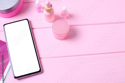 Mockup mobile phone on table with cosmetics, lifestyle stagging photo