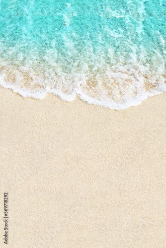 Soft ocean wave on white sand beach background © Oleandra9
