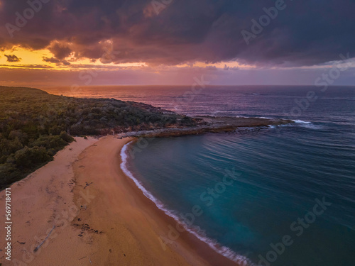 Rain clouds and dawn over the beach, sea and mountain