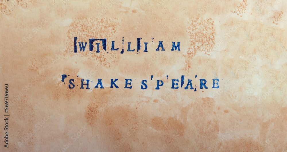 The name of the great poet and playwright William Shakespeare is written in stamped letters in dark blue ink on textured aged paper. Good literature, reading list, favorite authors