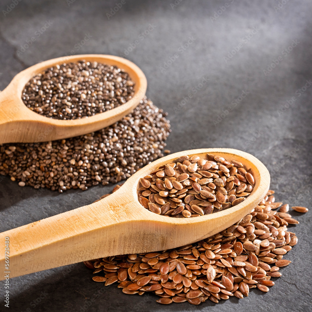 Organic flax and chia seeds in the spoons - Linum usitatissimum, Salvia hispanica Organic flax and chia seeds in the spoons - Linum usitatissimum, Salvia hispanica