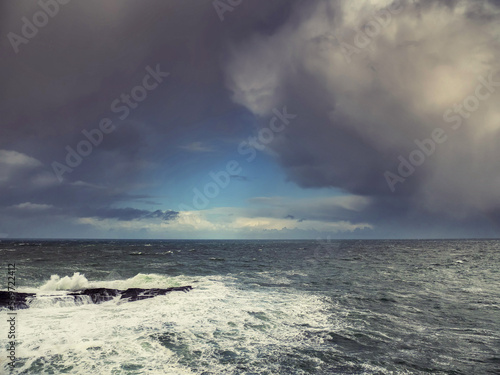 Stunning Irish seascape with rough stone coast line and powerful Atlantic ocean. Kilkee area, Ireland. Dramatic sky. Detailed nature scene. Popular travel and sightseeing area © mark_gusev