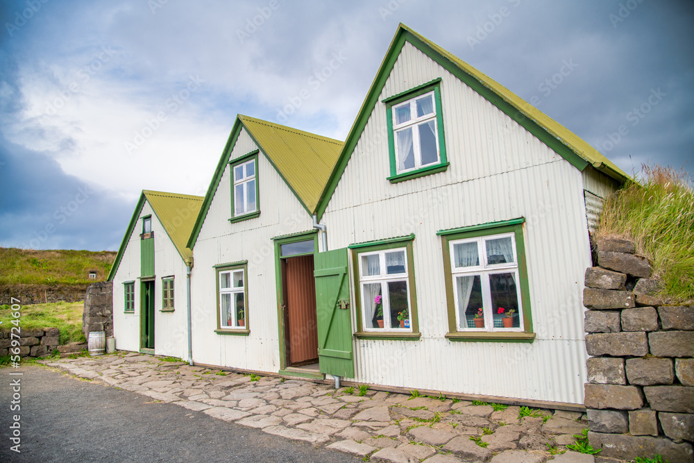 Green houses of Iceland in summer season, surrounded by vegetation Green houses of Iceland in summer season, surrounded by vegetation