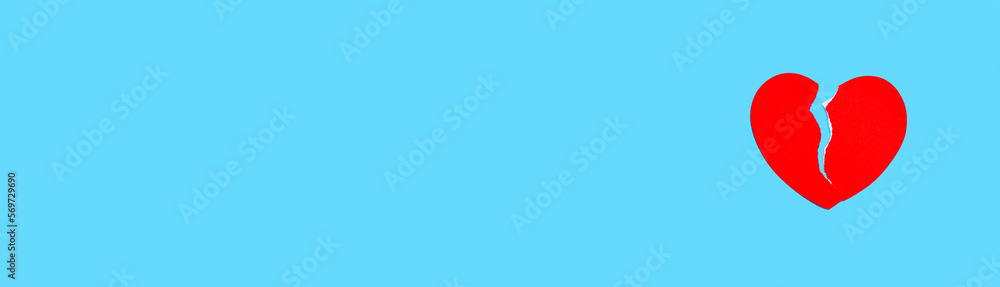 Red broken heart on a blue background. The concept of love addiction, quarrel with boyfriend, depression, difficult life moment, disappointment in love Red broken heart on a blue background. The concept of love addiction, quarrel with boyfriend, depression, difficult life moment, disappointment in love
