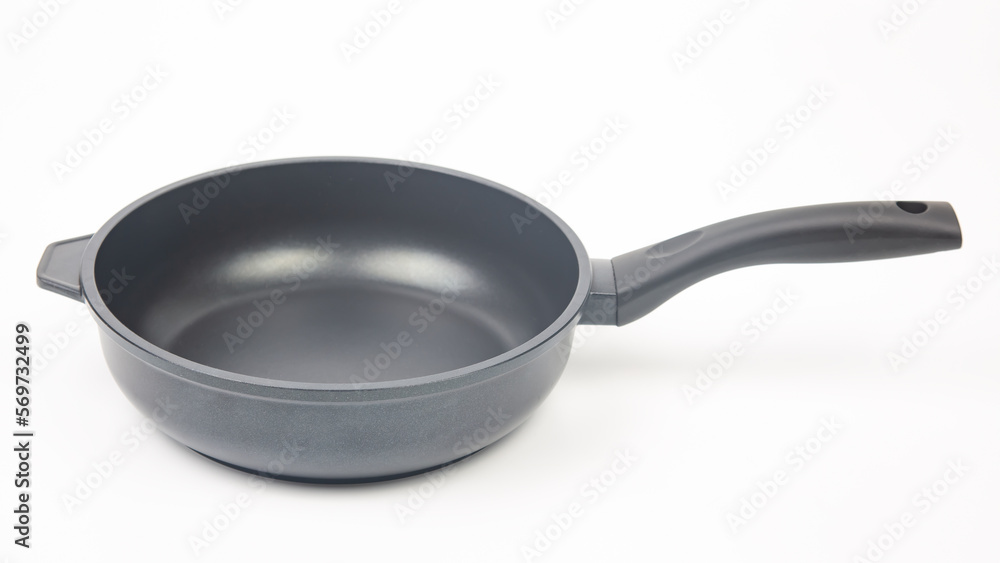 Black frying pan with non-stick teflon coating on white background Black frying pan with non-stick teflon coating on white background
